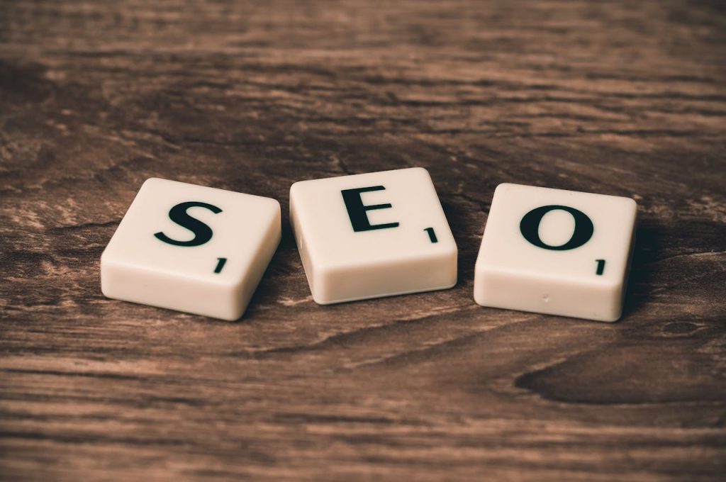 three-white-and-black-scrabble-tiles-on-brown-wooden-surface-270637 Scrabble tiles spelling SEO on a wooden surface. Ideal for digital marketing themes.